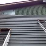 House with new vinyl siding being installed