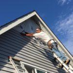 Stefan at work on siding near roof