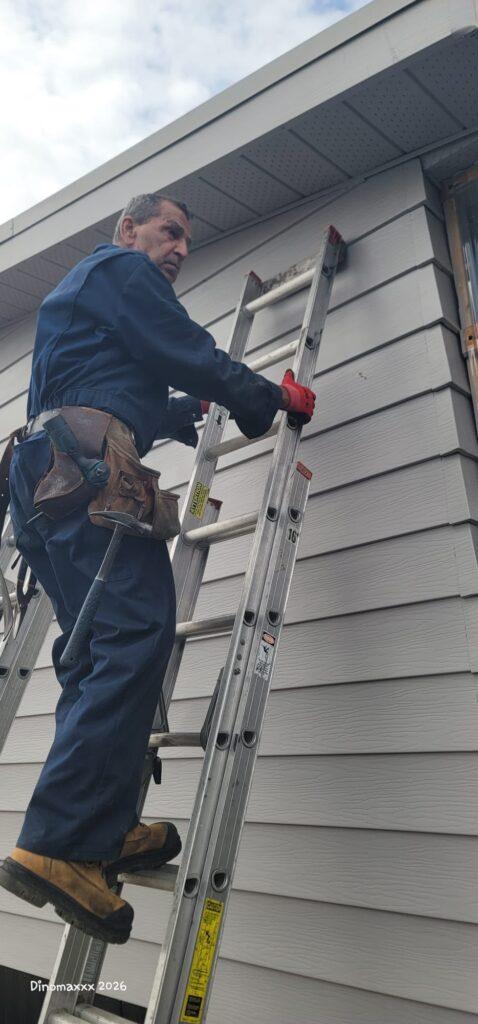 Stefan on ladder while working on soffits
