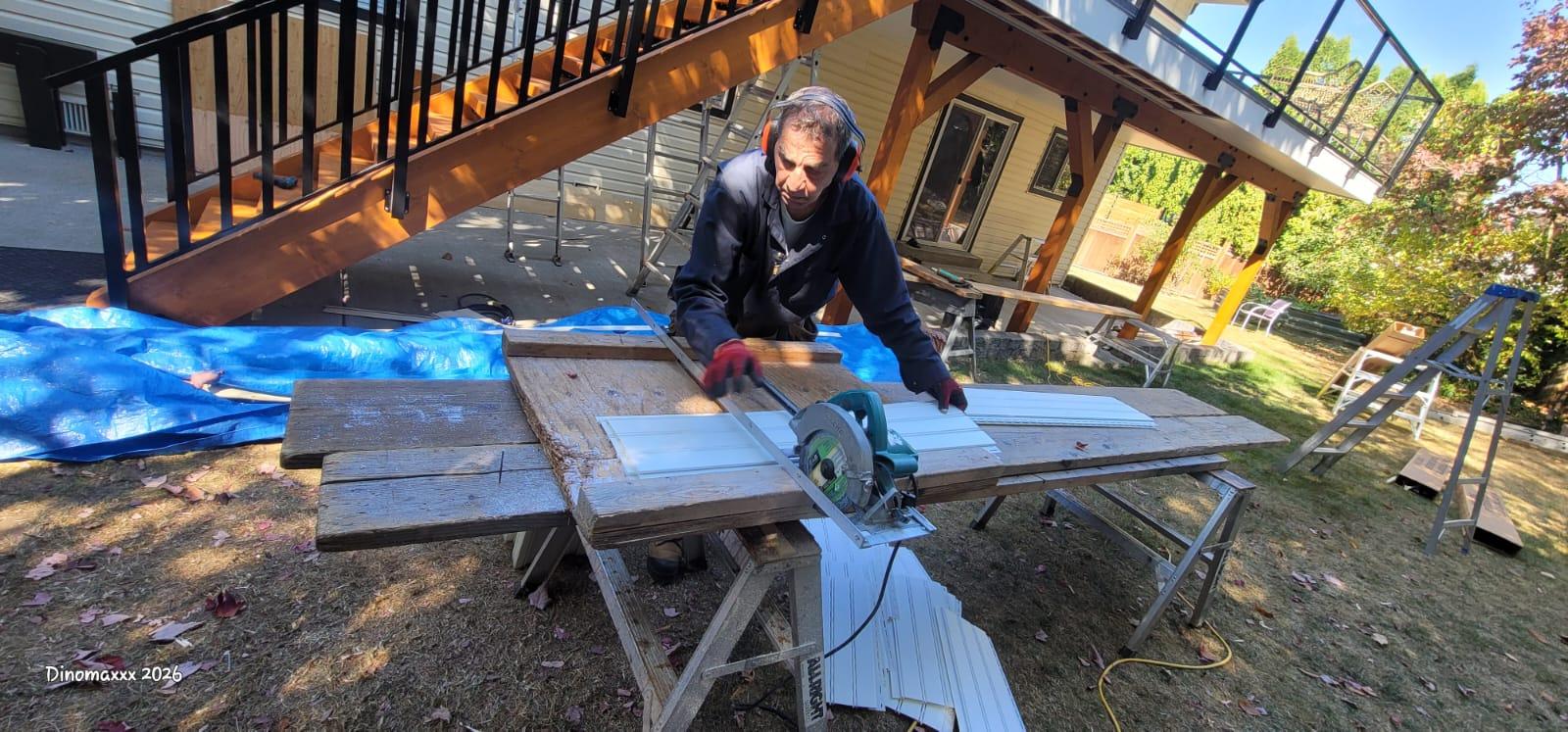 Stefan cutting soffits in backyard