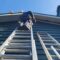 Stefan from Sunny Exteriors on ladder replacing soffits